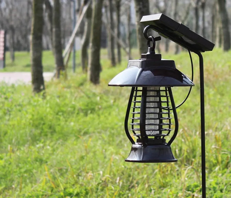 White and black solar-powered electronic mosquito lamp for garden outdoor insect control.