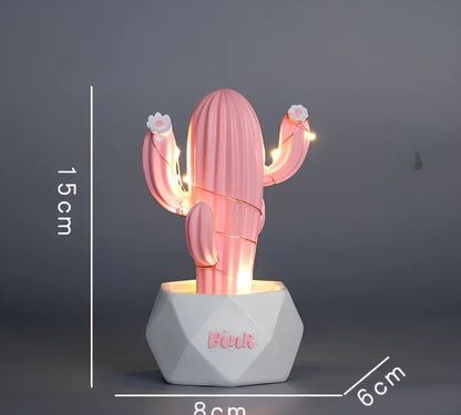 Cactus-shaped resin night light in gold finish measuring 15cm tall with warm LED glow