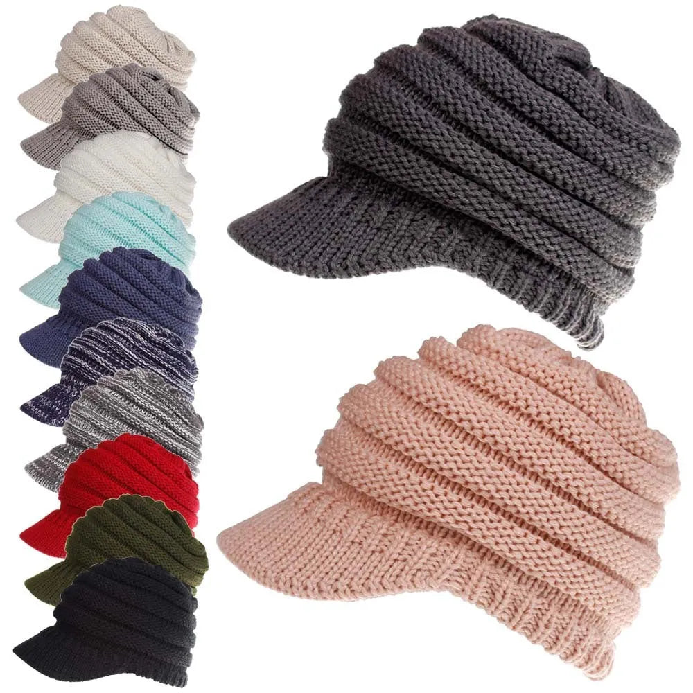 Woman wearing a light grey knitted ponytail beanie with her ponytail pulled through the hole in the back.