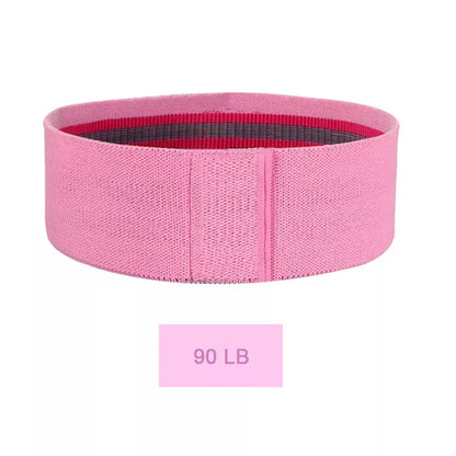 Squat resistance band hip ring in pink, purple, and green for lower body workouts