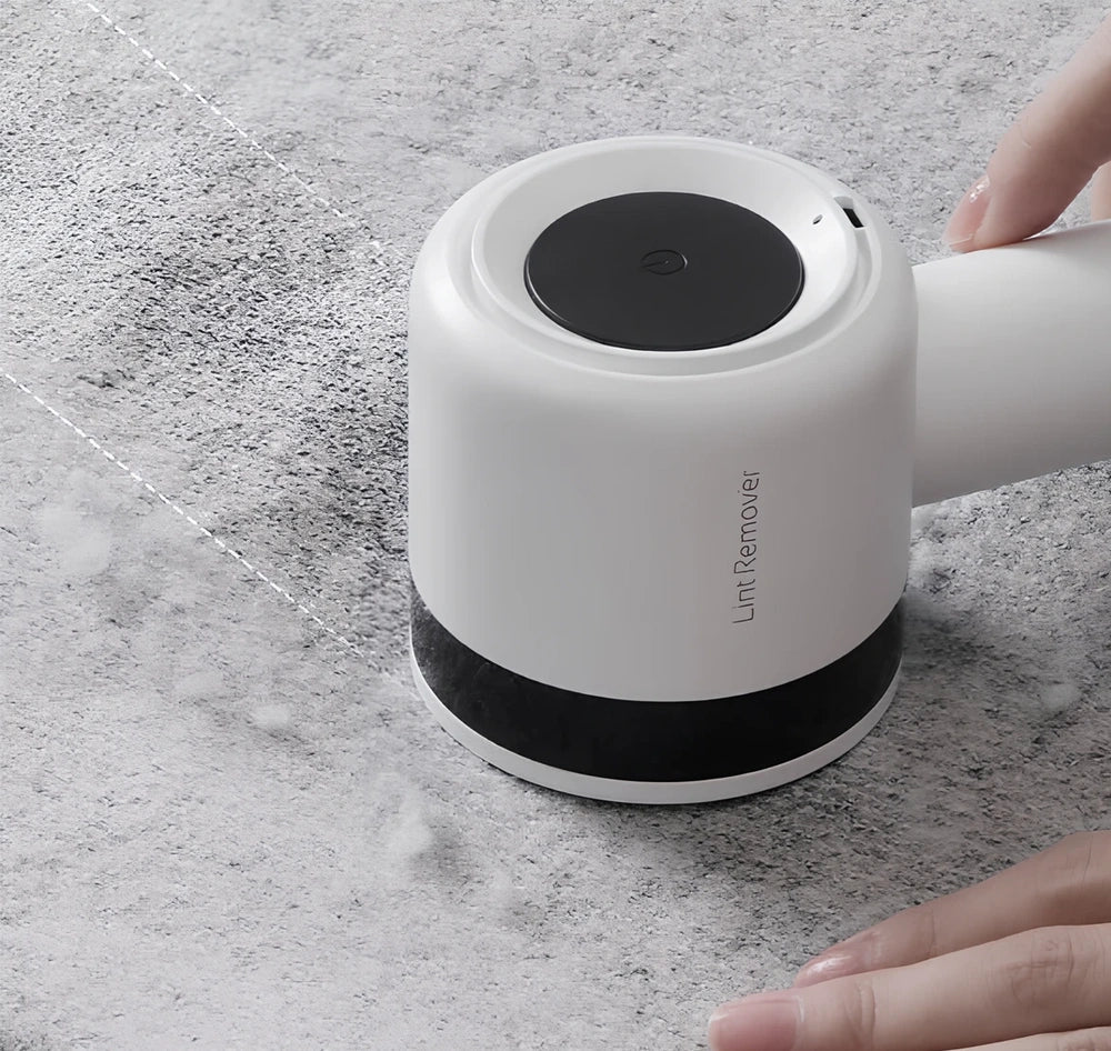 White rechargeable lint remover with detachable head and USB charging cable