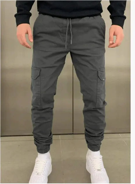 Men's loose-fit casual trousers with elastic waistband and patch pockets in army green colour