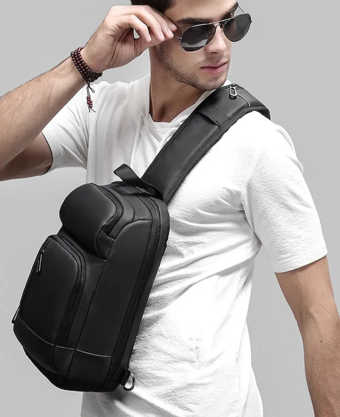 Black outdoor leisure shoulder bag with air cushion strap and multiple internal compartments