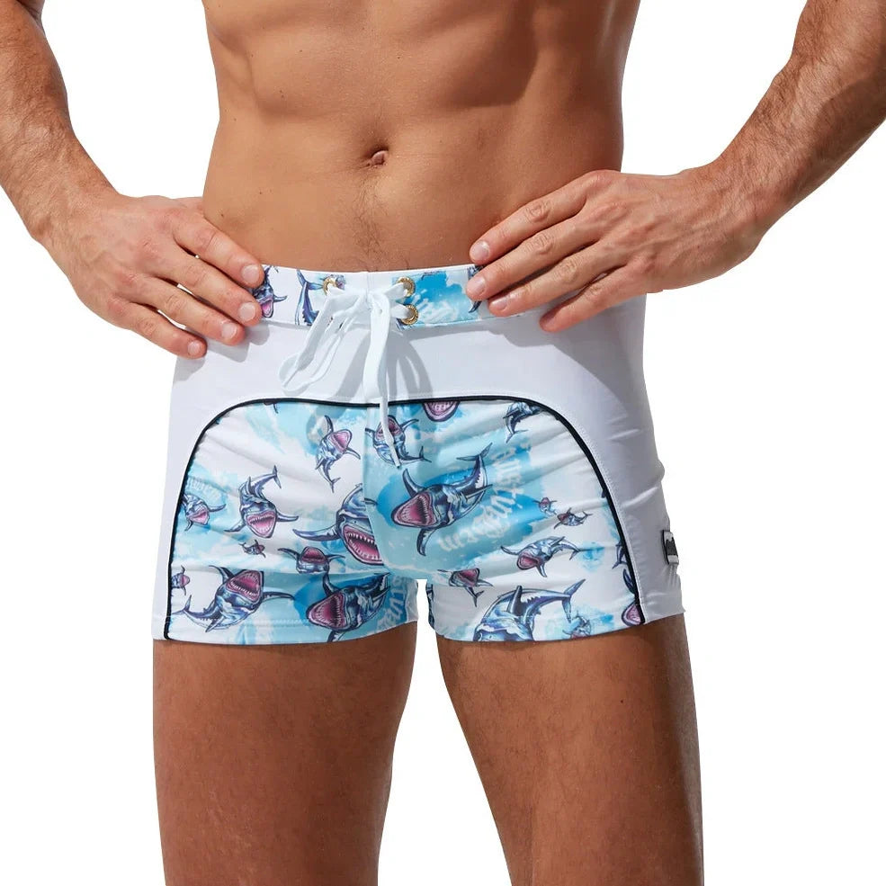 Men's nylon boxer shorts with floral and shark print designs showing deep purple, light purple, multicoloured options