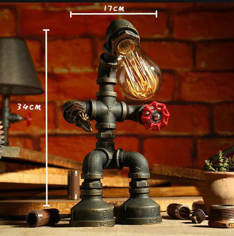 Vintage industrial iron pipe table lamp with soft, warm lighting and a green bronze finish