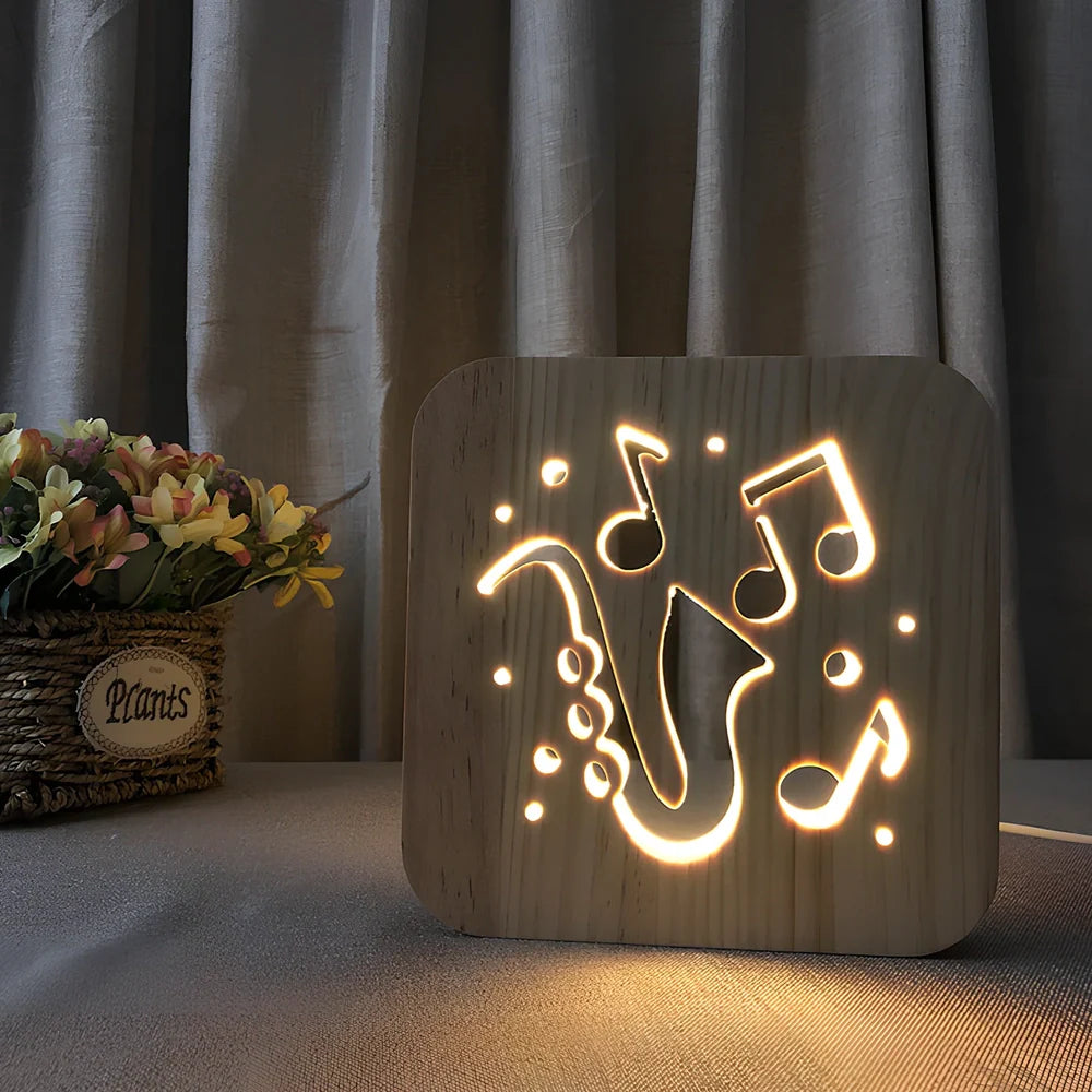 Wood-carved music instrument LED night light with USB cable showing guitar, saxophone, and violin designs