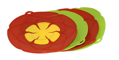 Green silicone spill stopper pan lid on cooking pot showing flexible edges and steam vent