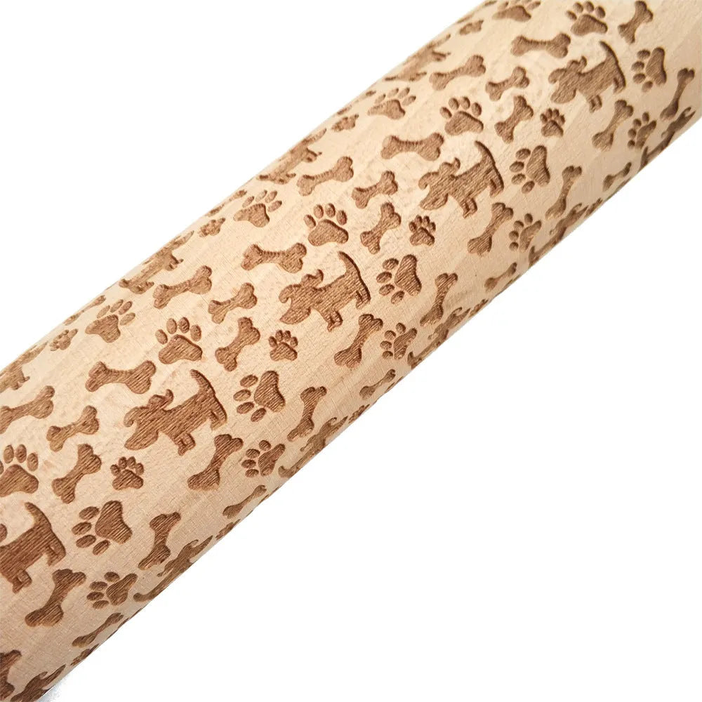 Wooden rolling pin with engraved Christmas patterns including reindeer and snowflakes on a 45cm long barrel.