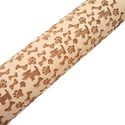 Wooden rolling pin with engraved Christmas patterns including reindeer and snowflakes on a 45cm long barrel.