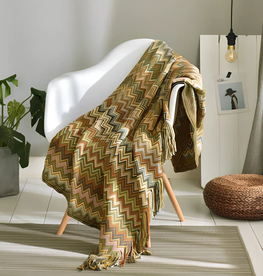 130x150cm knitted acrylic blanket with 10cm fringe detailing in beige colour draped over sofa