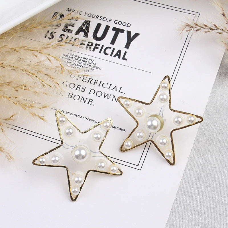 Elegant pearl stud earrings with peach heart and star design, made with premium materials for a stylish and versatile accessory.