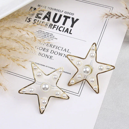 Elegant pearl stud earrings with peach heart and star design, made with premium materials for a stylish and versatile accessory.