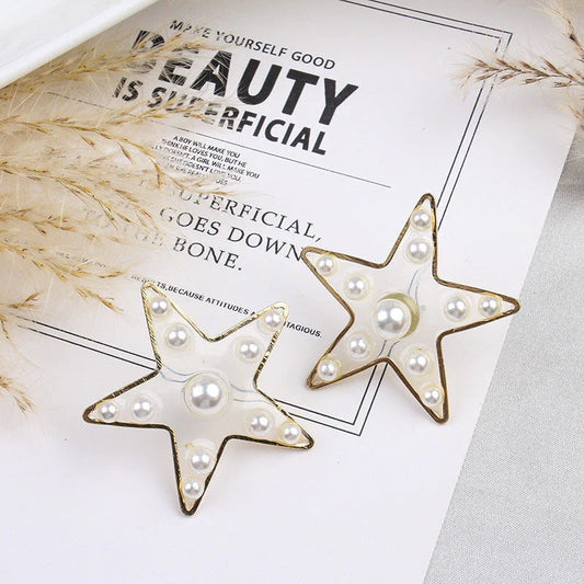 Elegant pearl stud earrings with peach heart and star design, made with premium materials for a stylish and versatile accessory.