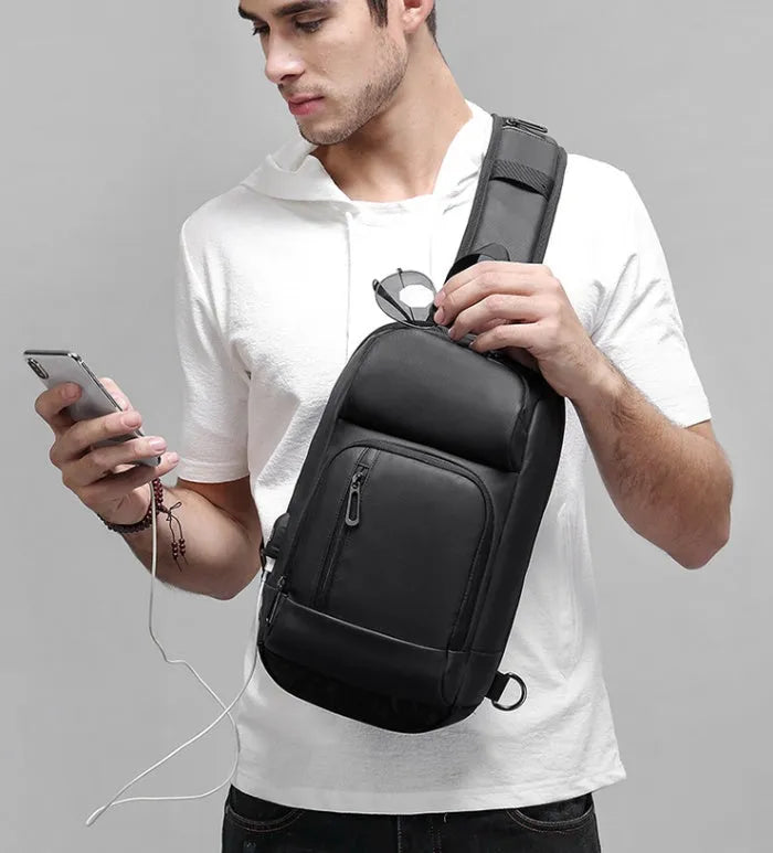 Black outdoor leisure shoulder bag with air cushion strap and multiple internal compartments