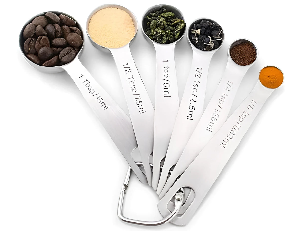 Six stainless steel measuring spoons with engraved markings and D-shape ring, sizes 1/8 tsp to 1 Tbsp