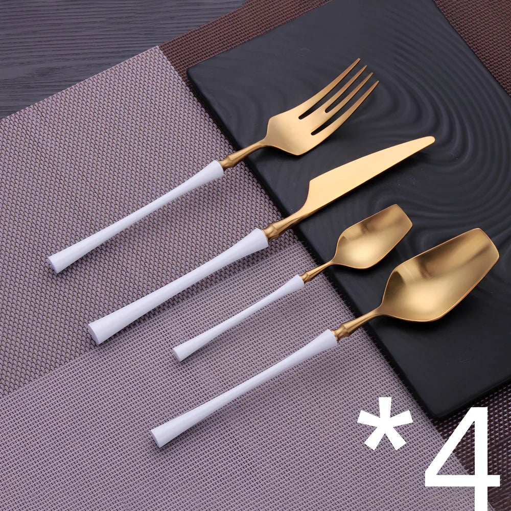 Four-piece stainless steel cutlery set showing main knife, fork, spoon, and teaspoon with mirror finish