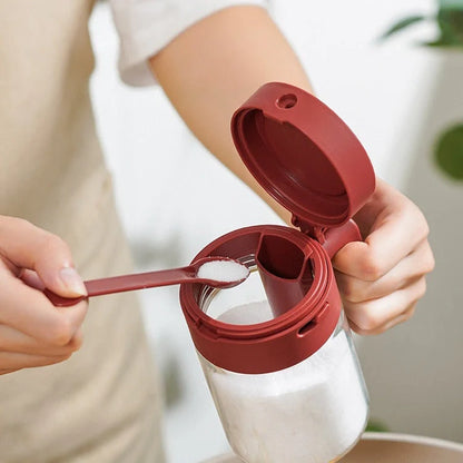 Small glass seasoning jars with lids and spoons in various colors for kitchen organization