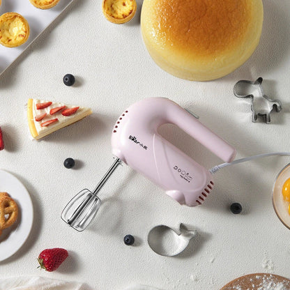 Pink electric hand whisk with stainless steel attachments for whipping eggs and cream