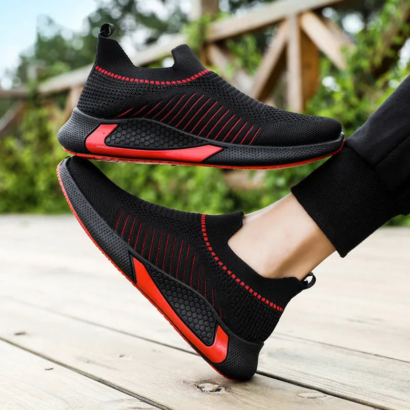 Men's black and white striped mesh slip-on sneakers with lace-up front.