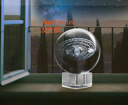 Solar system crystal ball showing planets inside K9 optical crystal sphere on metallic base