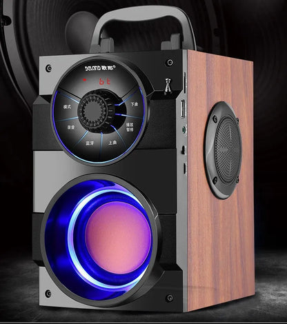 Black portable mini home audio system with built-in subwoofer, 3.5mm audio port, and USB charging cable