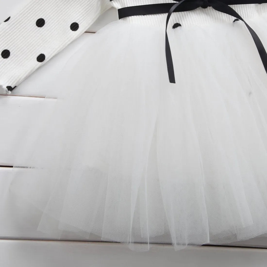 Baby girl's long sleeve black tutu lace dress with lace trim, shown on a hanger.