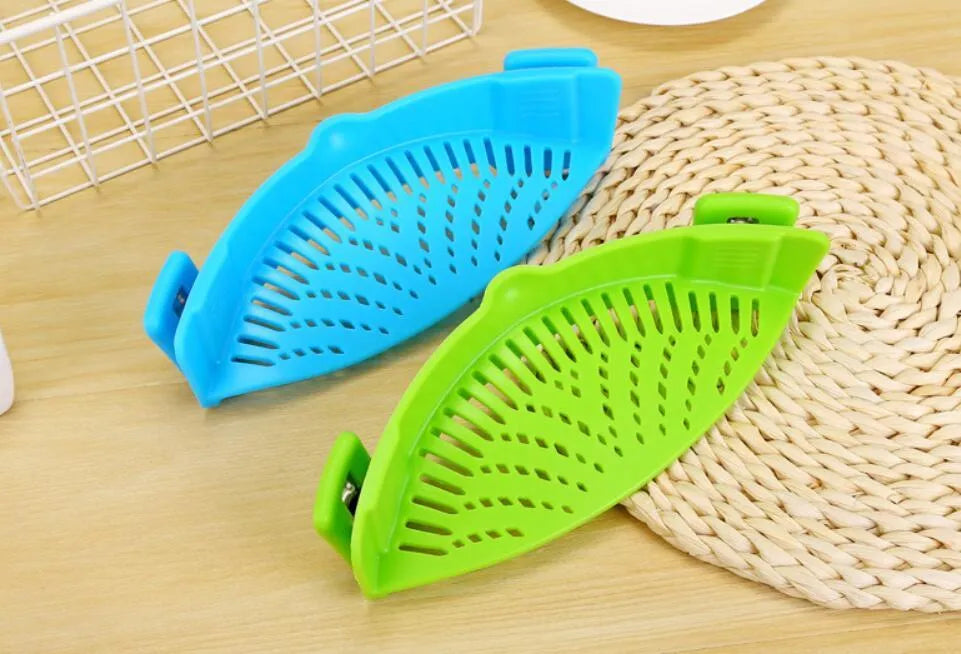 Silicone clip-on kitchen strainer with stainless steel frame attached to pot rim