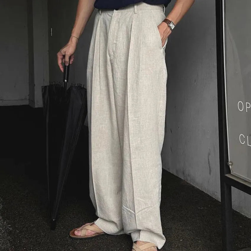 Men's apricot cotton linen trousers with elastic waistband and pencil leg opening on hanger