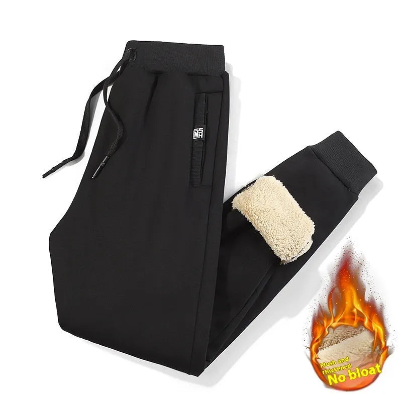 Grey fleece-lined men's cotton track pants with a drawstring waist shown in an oversized fit.