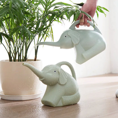 Pink elephant-shaped watering can with long nozzle for children and indoor plants.