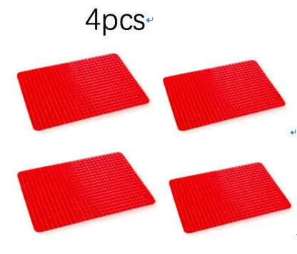 Red silicone pyramid grid cooking mat on a kitchen counter