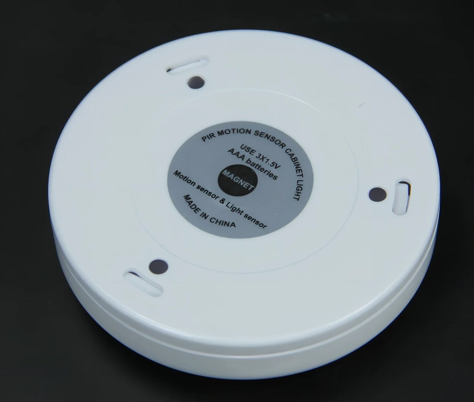 White motion-sensing LED cabinet lamp with magnetic back for wireless installation