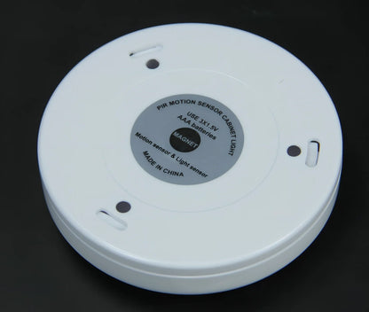 White motion-sensing LED cabinet lamp with magnetic back for wireless installation