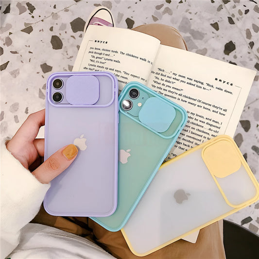 Slim silicone iPhone case with a frosted frame around the camera lens, shown in a choice of solid colours.