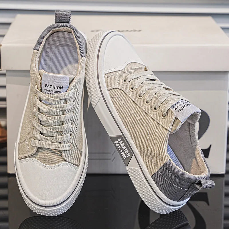 Men's low-top blue canvas skate shoes with round toe and flat heel on a white background.
