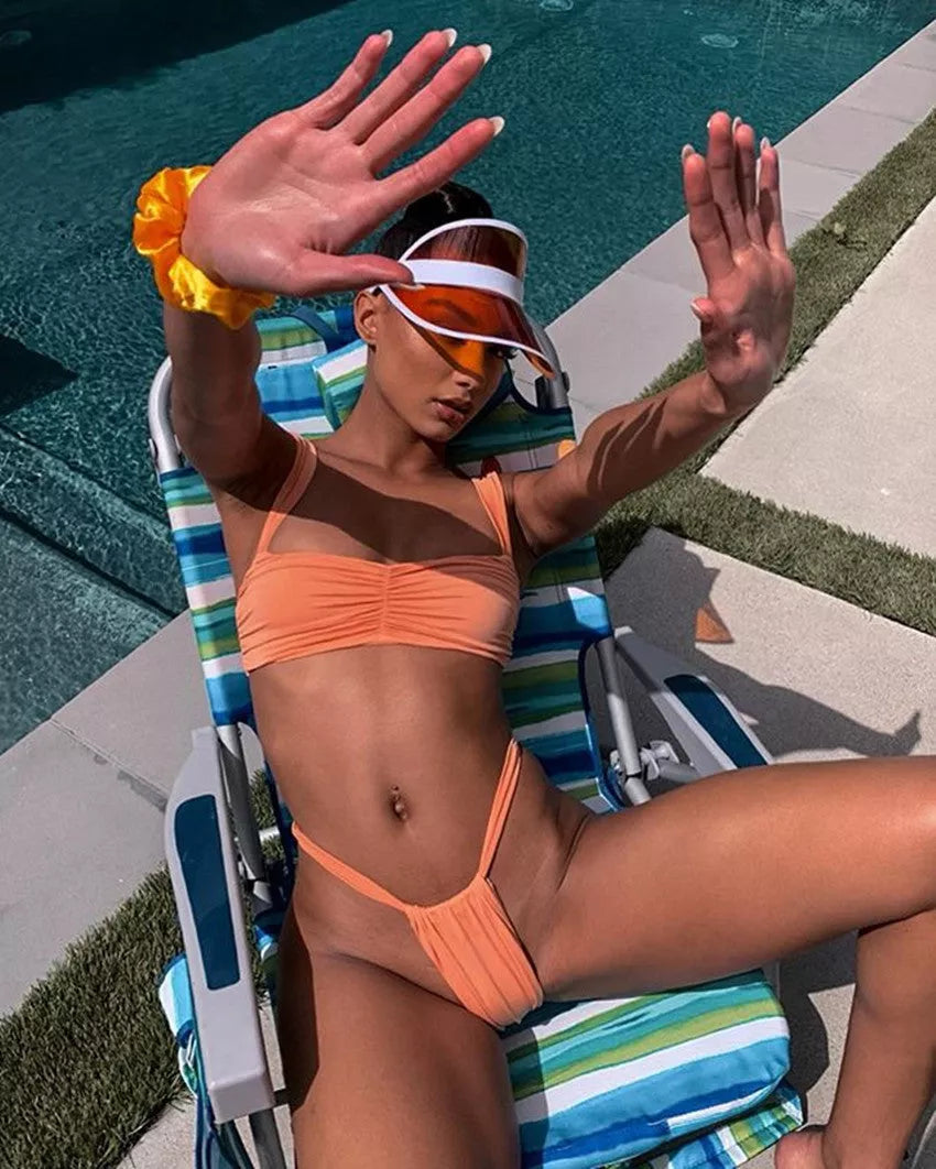 Solid color split bikini swimsuit in orange with nylon fabric and polyester lining