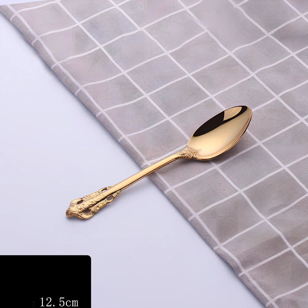 Four-piece stainless steel cutlery set showing main knife, fork, spoon, and teaspoon with mirror finish