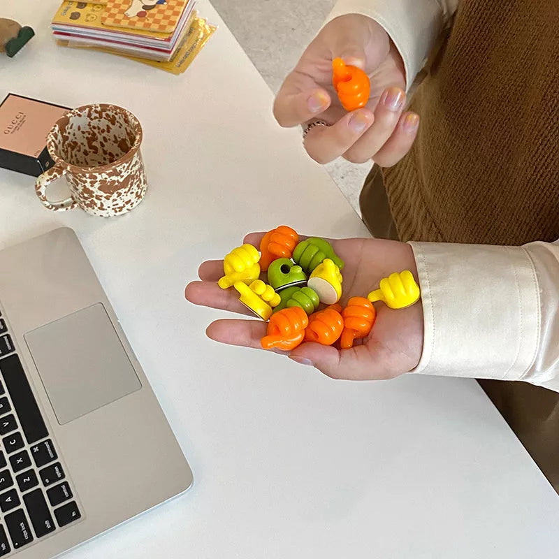 Silicone thumb wall hooks in various colors for organizing kitchen and bathroom items