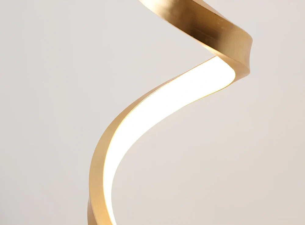 Modern table lamp with curved design, metal base, and acrylic shade offering remote-controlled dimming between warm and white light