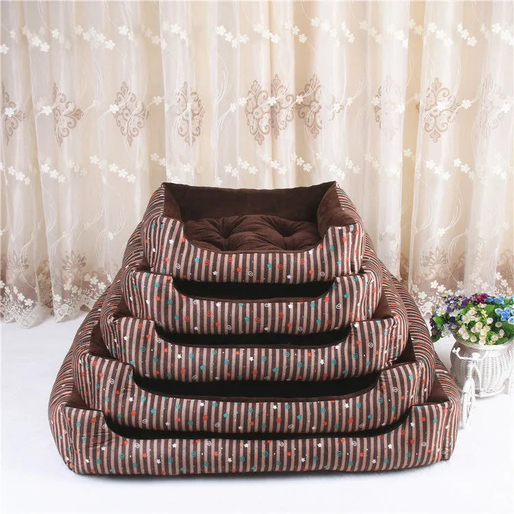 Oval cloth pet bed for dogs or cats in a striped colour pattern, showing its soft cushion shape.