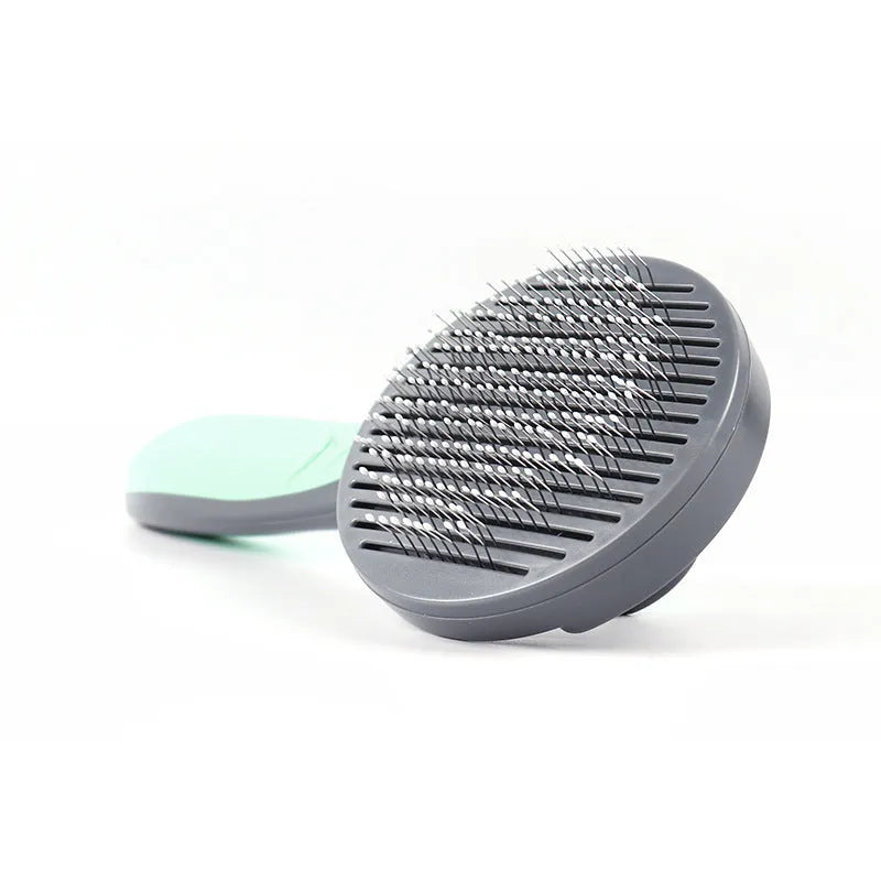 One button dog hair removal comb with stainless steel pins, 19.3cm long, in mint green or gentleman grey