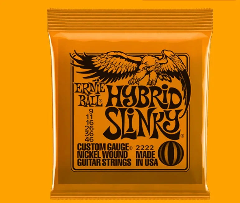 Coils of nickel-plated electric guitar strings and bass strings showing their metallic shine.