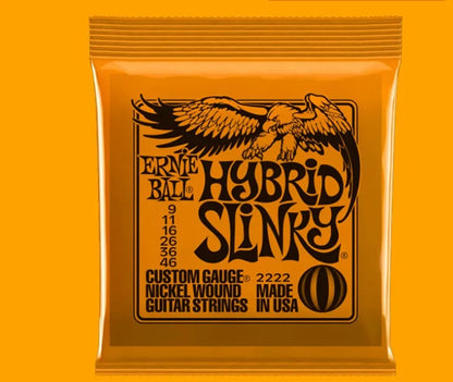 Coils of nickel-plated electric guitar strings and bass strings showing their metallic shine.