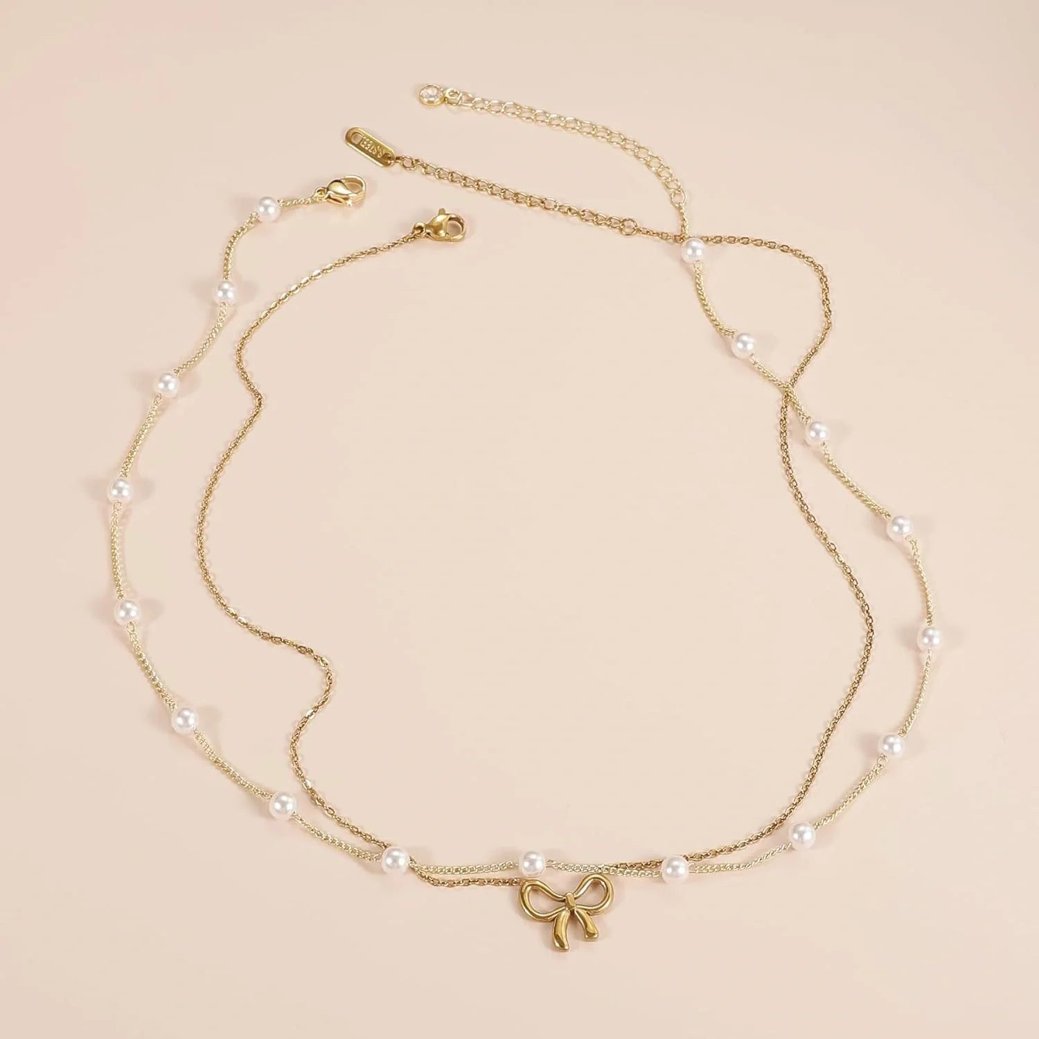 Double layer pearl choker with bow pendant in gold and silver options