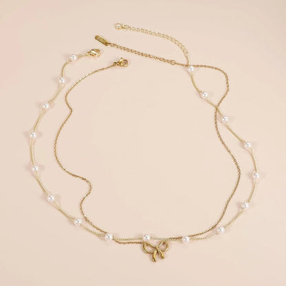 Double layer pearl choker with bow pendant in gold and silver options