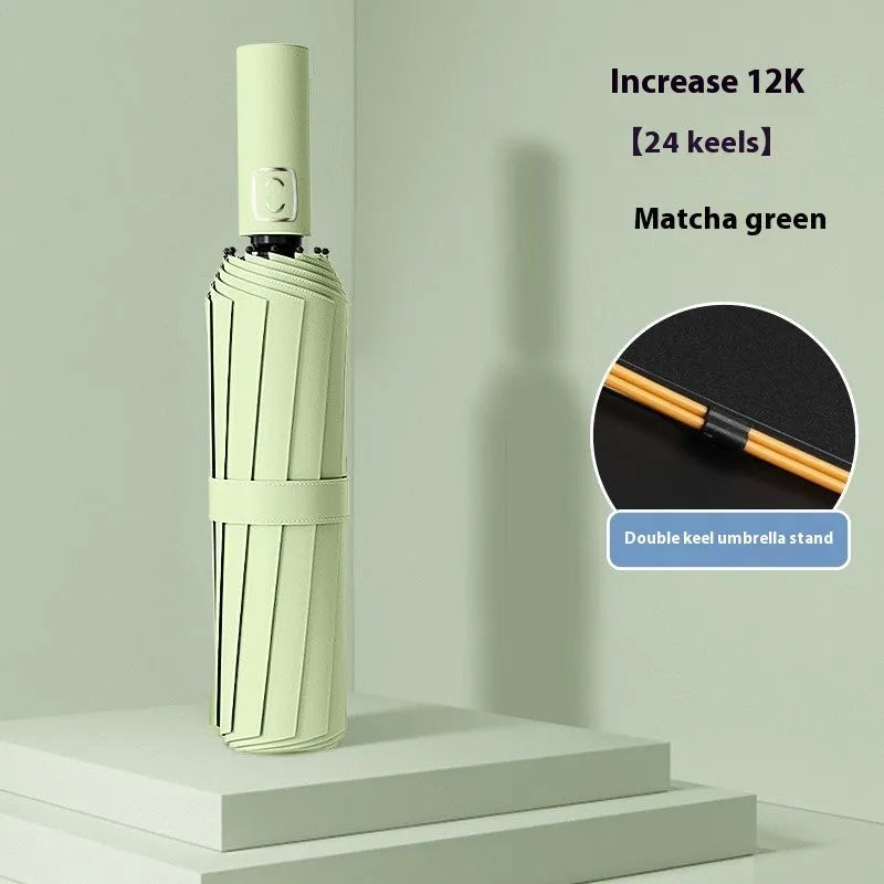 Large triple-folding manual umbrella open, showing its full canopy size and plastic handle.