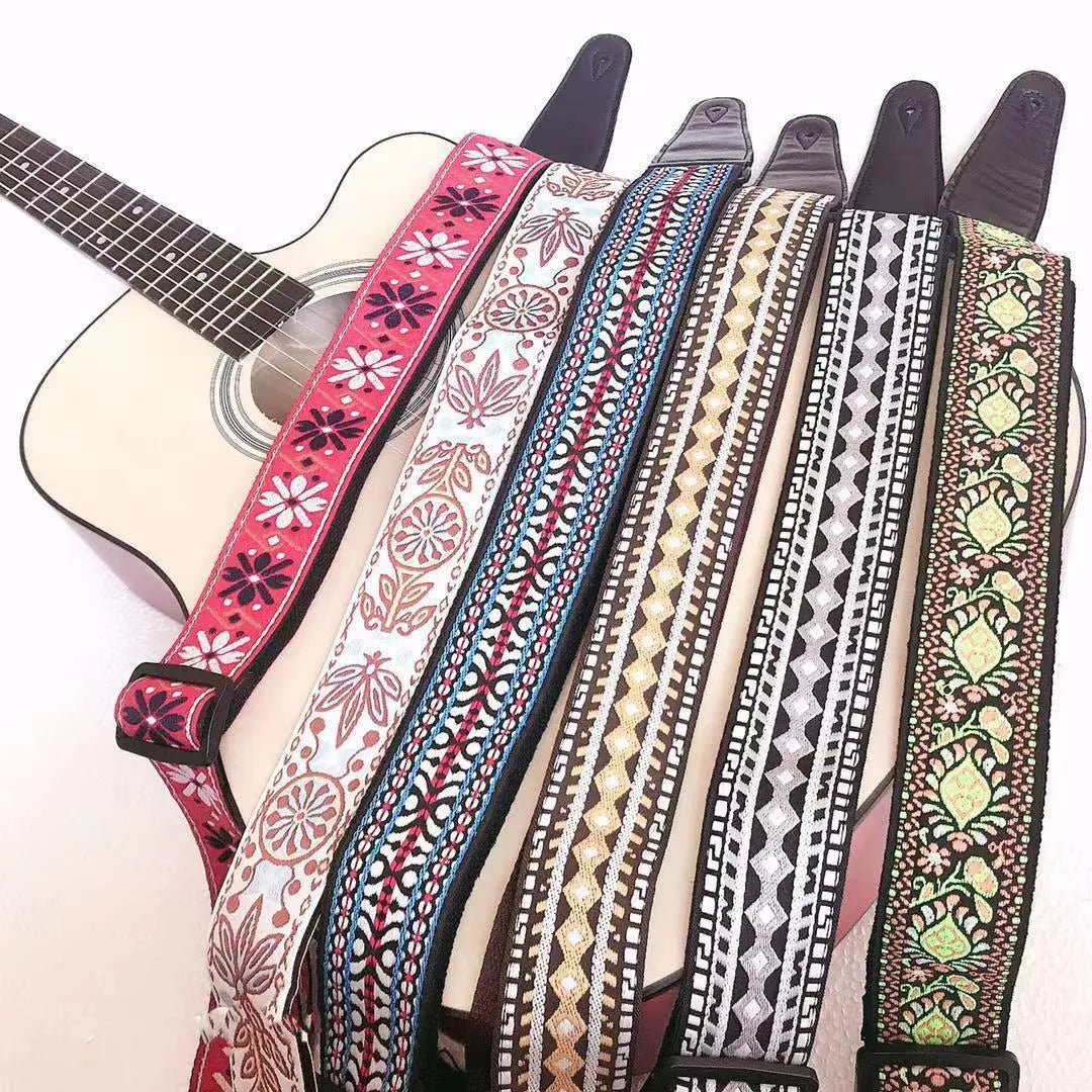 Adjustable embroidered guitar strap with durable webbing and intricate design