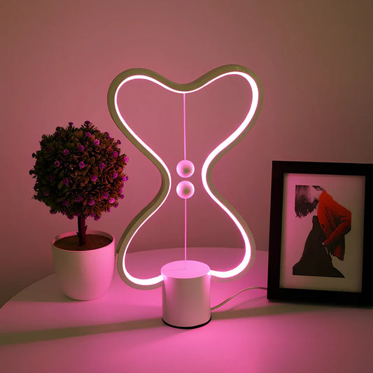 Balance lamp with suspended magnetic netballs and embedded LED lighting in frame