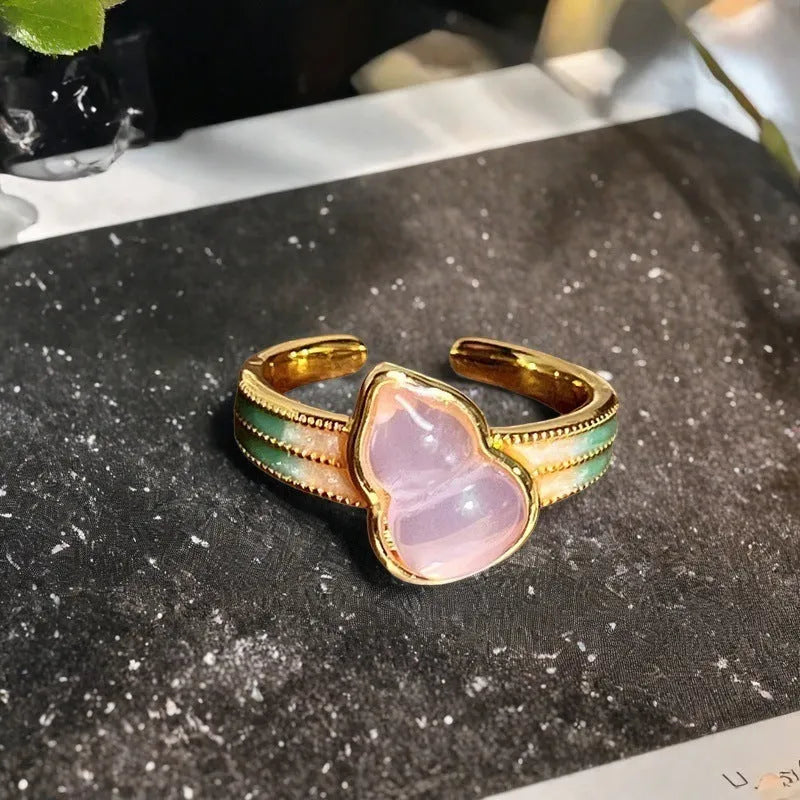 Adjustable copper gourd ring with zircon stones showing flower and bow design elements