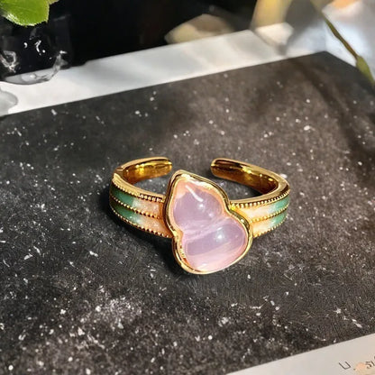 Adjustable copper gourd ring with zircon stones showing flower and bow design elements